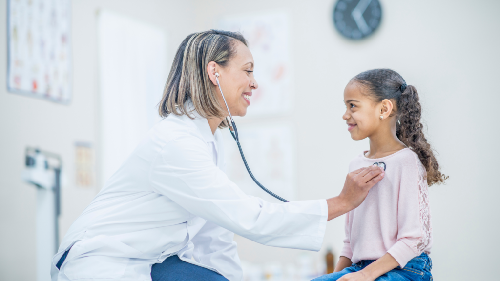 Smiling female locum tenens physician uses stethoscope to examine a young woman